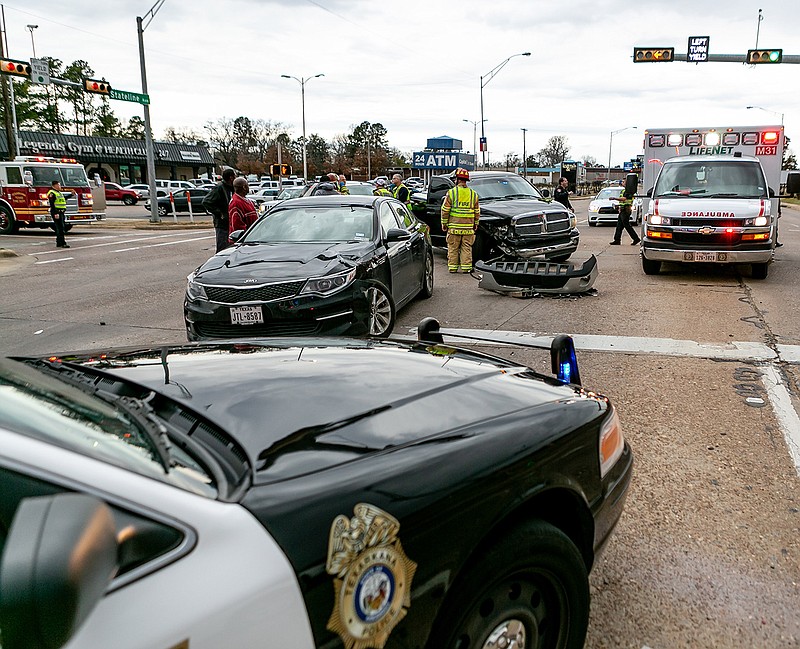 Three vehicles sit at State Line Avenue and College Drive on Monday after  ablack Dodge Ram heading south ran a red light and hit a Kia Optima and a Buick Rendezvous that were both turning onto State Line. No major injuries were reported, Texarkana, Ark., police say.