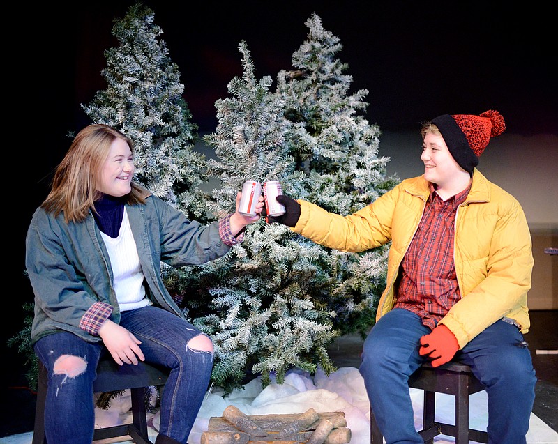 Sally Ince/ News TribuneLydia Lam, left, and Regan Bohanan cheers their drinks Wednesday January 23, 2019 as they play in the "They Fell" scene during a dress rehearsal at Miller Performing Arts Center. The scene illustrates stuggling within the dating world and friends coming to realize their love for one another.  