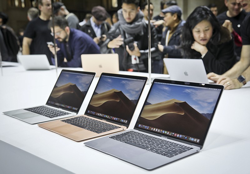 FILE- In this Oct. 30, 2018, file photo Apple's new MacBook Air computers are displayed during the company's showcase of new products in the Brooklyn borough of New York. Apple Inc. reports earnings Tuesday, Jan. 29, 2019. (AP Photo/Bebeto Matthews, File)