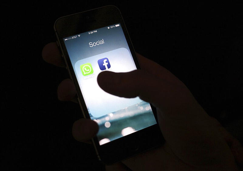 This Feb. 19, 2014, file photo shows the Facebook app icon on an iPhone in New York.