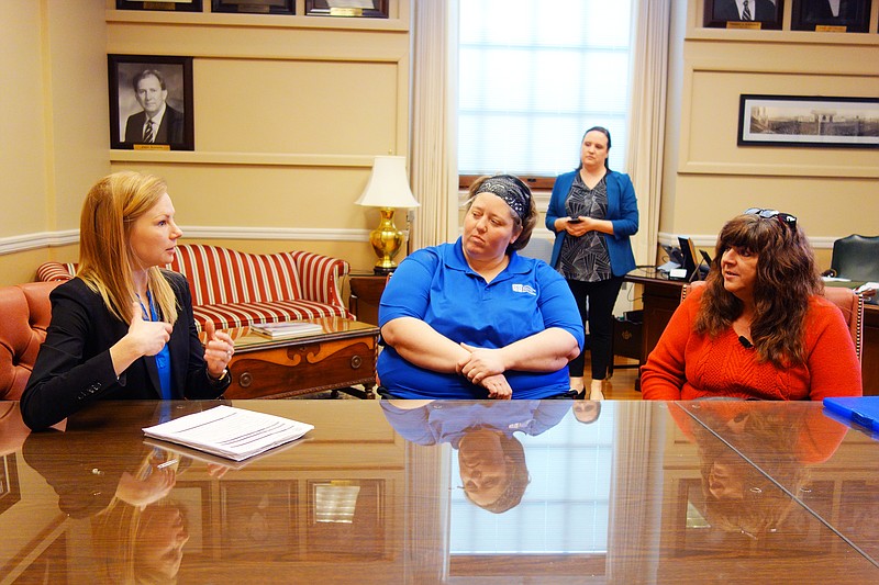 <p>Helen Wilbers/For the News Tribune</p><p>State Auditor Nicole Galloway, left, talks to Jennifer Graves and Cheri Wilson, of New Bloomfield, in April. Several New Bloomfield residents presented a petition with 102 signatures asking Galloway’s office to audit the town last year.</p>