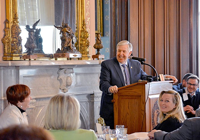 Gov. Mike Parson laughs with reporters Thursday during the annual Missouri Press Association/Associated Press Day lunch at the Governor's Mansion. 