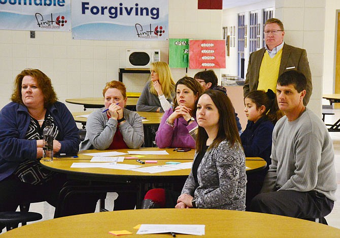 Attendees to a town hall meeting Thursday at Thomas Jefferson Middle School listen to Jefferson City Public Schools Superintendent Larry Linthacum and Chief of Learning Brian Shindorf discuss options for school start times.