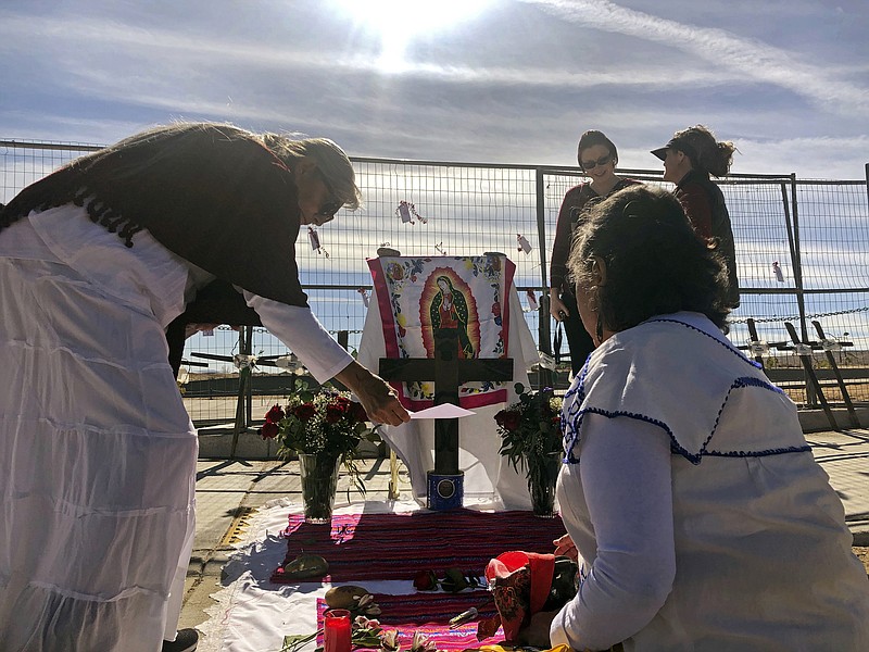 Sylvia Ledesma, left, and Lorrain Cordova prepare for a service to remember the victims and call for more protection for marginalized and vulnerable women in Albuquerque, N.M., on Saturday, Feb. 2, 2019. Ten years ago, police began unearthing the remains of 11 women and an unborn child found buried on Albuquerque's West Mesa, marking the start of a massive homicide investigation that remains open. Known as the West Mesa killings, the victims' deaths have resulted in no arrests, despite the massive homicide investigation police launched after discovering the makeshift graves. (AP Photo/Mary Hudetz)