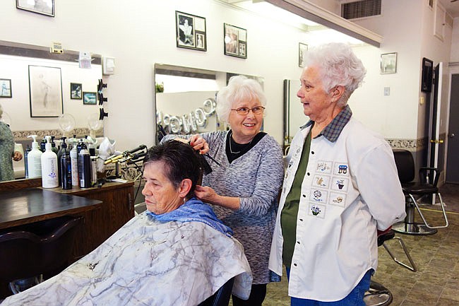 Lyda Vaughan, center, chats with regulars Maxine Garriott, left, and Jackie Britts during one of her final days on the job at Lyda's Beauty Shop. She's retiring after almost 52 years of cutting hair in Fulton.