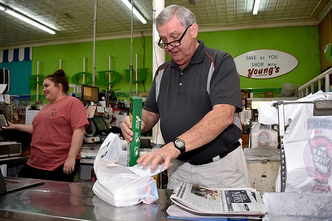  Perry Young, owner of Young's Grocery Store in Foreman, Ark., sacks groceries. Medical problems are causing Young to retire and if he doesn't find a buyer for the business, the town's only grocery store will soon close. Young said if that happens, Foreman residents will have to make a 40-mile round trip to get groceries.