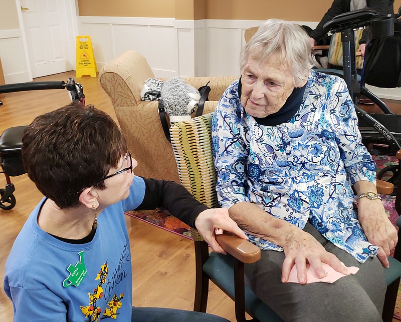 <p>Submitted</p><p>Bittersweet Garden Club members Kathy Laur chats with a resident at Heisinger Bluffs on Jan. 28 during the “A Pop of Color for a Gloomy Day” workshop.</p>