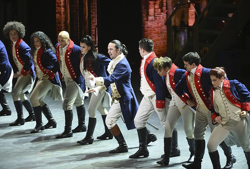 FILE - In this June 12, 2016 file photo, Lin-Manuel Miranda, center, and the cast of "Hamilton" perform at the Tony Awards in New York. Ever since the historical musical began its march to near-universal infatuation, one group has noticeable withheld its applause, historians. Many academics argue the onstage portrait of Alexander Hamilton is a counterfeit. Now they’re escalating their fight. (Photo by Evan Agostini/Invision/AP, File)