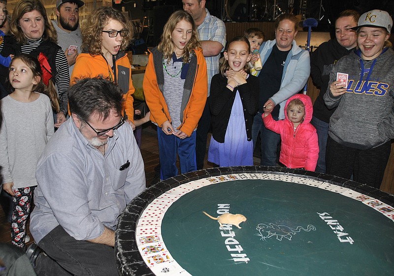 <p>Submitted photo</p><p>Onlookers cheer a mouse toward their chosen roulette card during a previous Callaway Cup Mouse Races event. In mouse roulette, attendees buy in and bet on which card the mouse will select. The mouse is placed in the middle of the wheel, and a payout goes to whoever chose the card the mouse steps on first.</p>