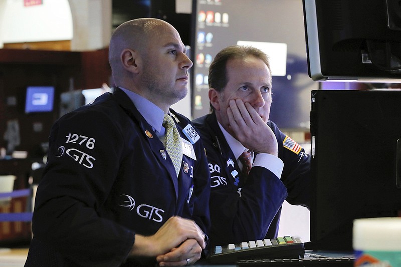 FILE- In this Jan. 30, 2019, file photo specialists Mario Picone, left, and Glenn Carrell work on the floor of the New York Stock Exchange. The U.S. stock market opens at 9:30 a.m. EST on Monday, Feb. 4.  (AP Photo/Richard Drew, File)