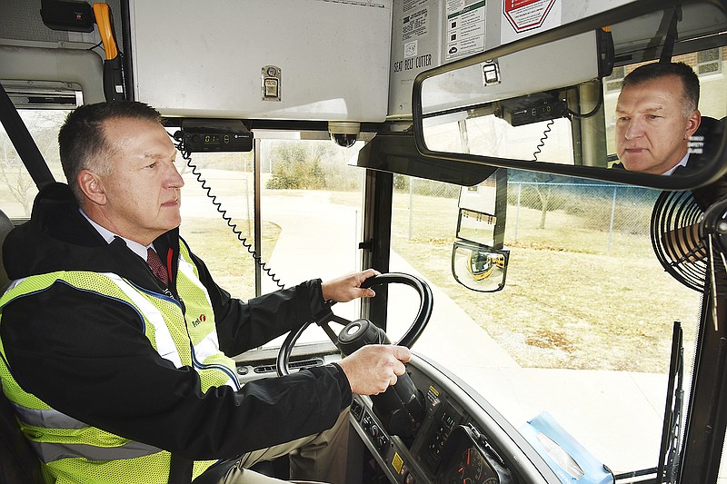 Jefferson City Public Schools Superintendent Larry Linthacum sits behind the steering wheel of Bus No. 2 on Monday at Thomas Jefferson Middle School. He drove the bus on the afternoon delivery route and intends to drive a bus once a month. The goal is to get a better idea of student behavior and to make sure students get to where they need to be on time.
