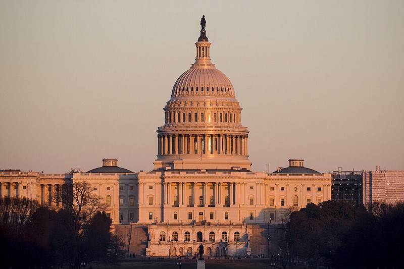 The light from the setting sun is reflected in the windows of the U.S. Capitol, Monday, Feb. 4, 2019, in Washington. 