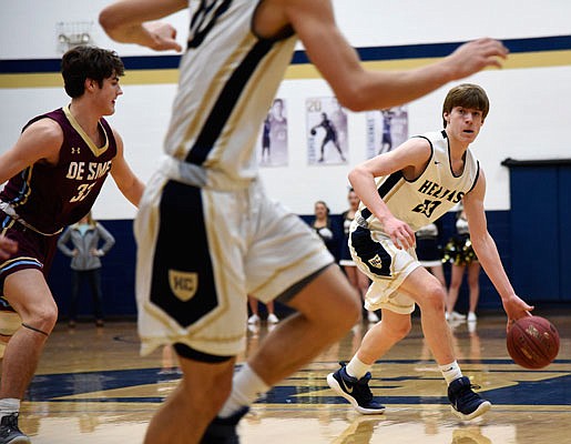 Colby LeCuru of Helias looks for a teammate to pass the ball to during Monday night's game against De Smet at Rackers Fieldhouse.