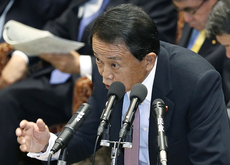 Japanese Finance Minister Taro Aso speaks during a budget committee meeting at the lower house of the parliament in Tokyo Tuesday, Feb. 5, 2019. Aso reluctantly apologized for saying childless people are to blame for the country's rising social security costs and its aging and declining population. Aso said Tuesday that he apologized if some people found his remarks "unpleasant." (Yohei Kanasashi/Kyodo News via AP)