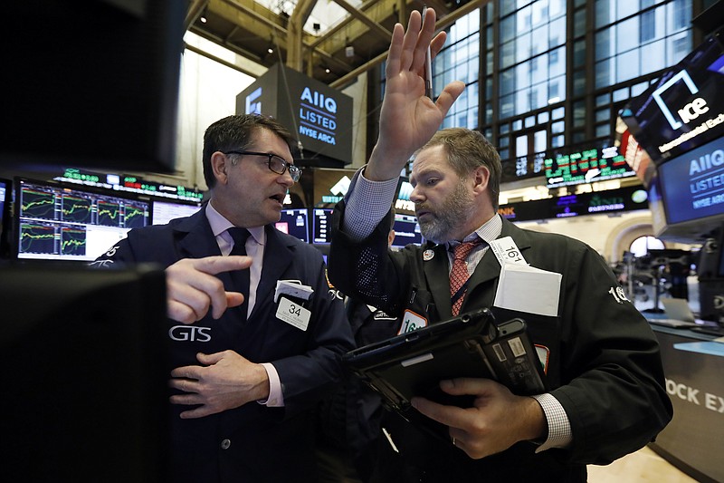 Specialist David Haubner, left, and trader Thomas McCauley work on the floor of the New York Stock Exchange, Tuesday, Feb. 5, 2019. Stocks are opening higher on Wall Street as investors welcomed some strong earnings reports from U.S. companies. (AP Photo/Richard Drew)