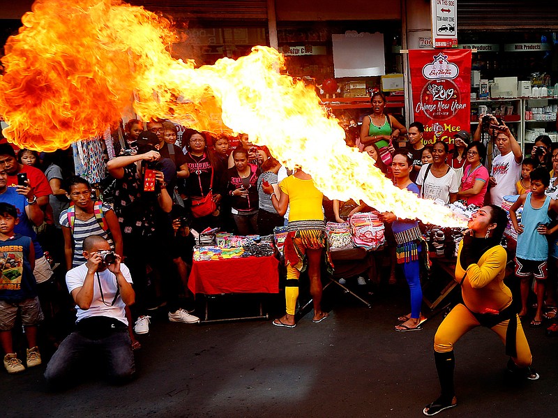 A fire-eater performs during celebrations of the Lunar New Year Tuesday, Feb. 5, 2019,  in the Chinatown district of Manila, Philippines. This year is the Year of the Earth Pig in the Chinese Lunar calendar and is supposed to represent abundance, diligence and generosity. (AP Photo/Bullit Marquez)