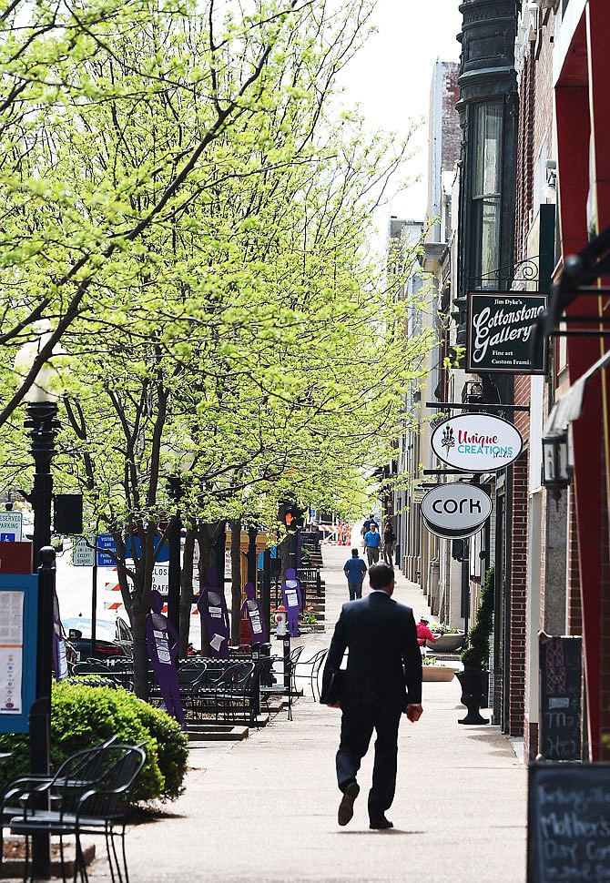 Pedestrians walk down High Street in downtown Jefferson City. (MAY 2018 FILE PHOTO)