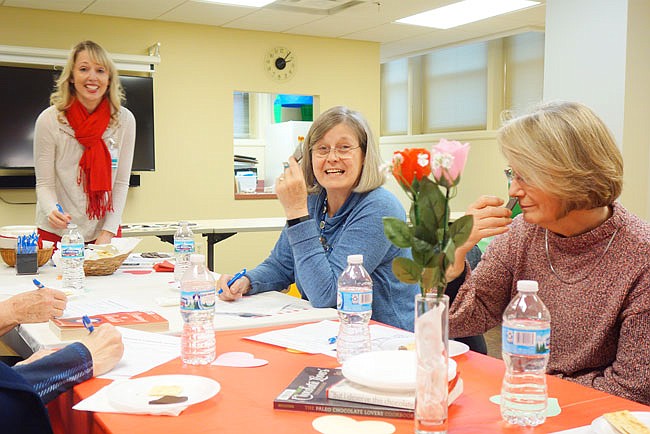 Dietitian Lucy Crain, far left, led a chocolate tasting event at the Callaway County Public Library on Wednesday afternoon. Joyce Airaghi and Jane Bible were among a small group gathered to savor the sweet treats.