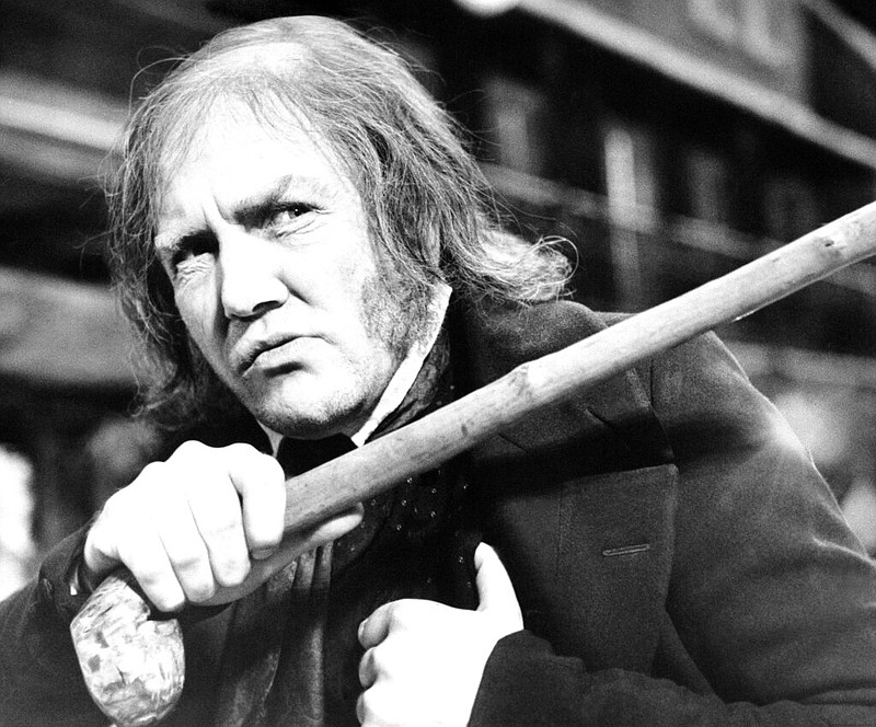 In this Jan. 15, 1970 file photo, British actor Albert Finney waves his cane while playing the title role in "Scrooge," at Shepperton Studios. British Actor Albert Finney, the Academy Award-nominated star of films from "Tom Jones" to "Skyfall" has died at the age of 82 his family said on Friday, Feb. 8, 2019. 