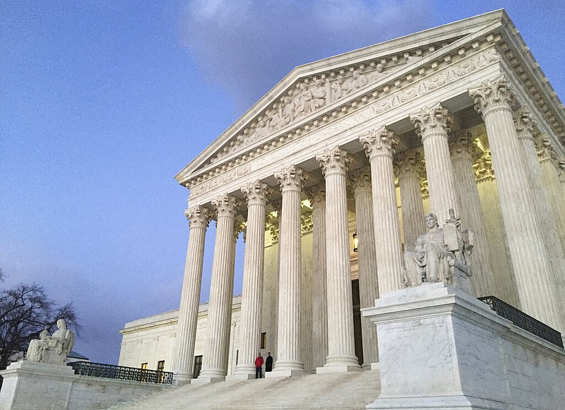 In this Feb. 13, 2016, file photo, people stand on the steps of the Supreme Court at sunset in Washington.The Supreme Court is stopping Louisiana from enforcing new regulations on abortion clinics in a test of the conservative court's views on abortion rights.