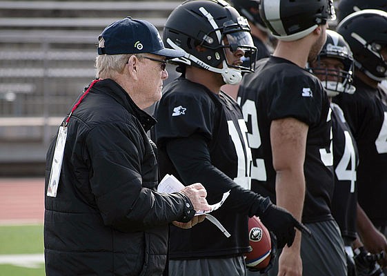 In this photo released by the Alliance of American Football, head of football and co-founder Bill Polian watches as players with the Birmingham Iron practice last month in San Antonio.
