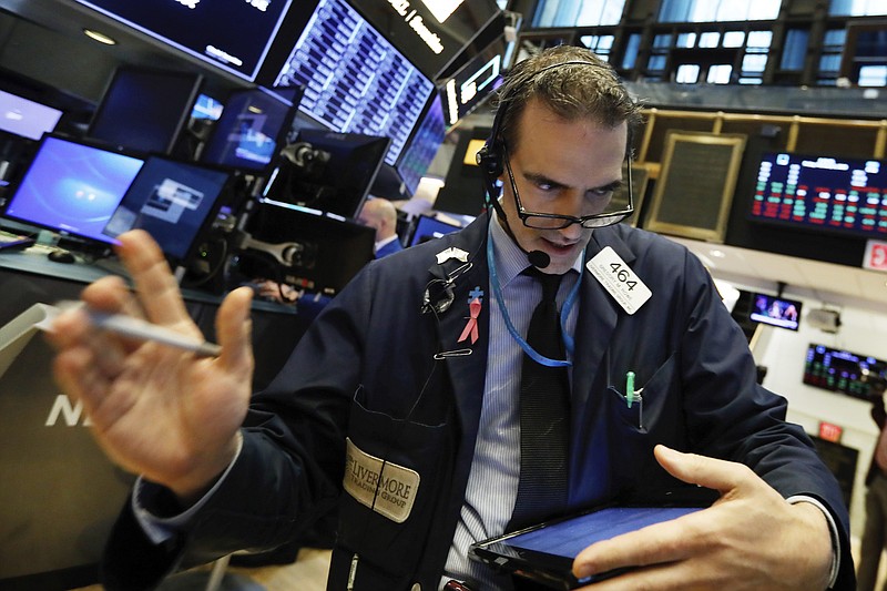 Trader Gregory Rowe works on the floor of the New York Stock Exchange, Friday, Feb. 8, 2019. Stocks are opening lower on Wall Street as a mixed bag of earnings reports didn't inspire investors to get back to buying stocks. (AP Photo/Richard Drew)