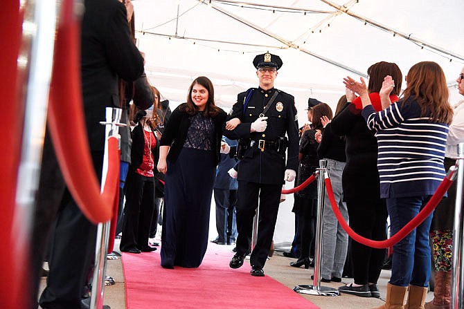 Rachel Wheeler is escorted into the A Night to Shine event, a prom for people with special needs, Friday at Capital West Christian Church. Members of the Jefferson City Fire Department escorted guests into the dance. As guests made their red-carpet entrance, they were provided with crowns and corsages and had the option to take part in shoe shines, makeovers, limo rides and a buffet dinner before the dancing began.