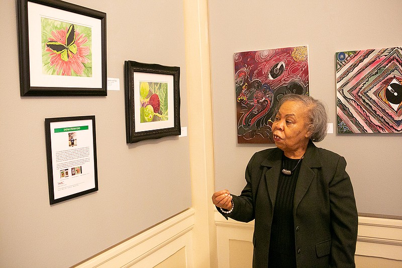  Dr. Teretha Harper of the Texarkana Regional Arts and Humanities Council explains one of the art pieces from the 17th annual Regional Celebration of African American Artists exhibit on display 
at The Regional Arts Center in Texarkana, Texas.