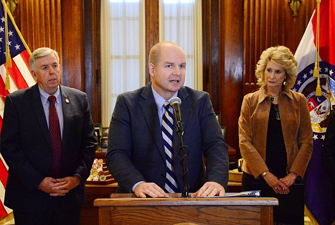 Shawn Strong, president of State Technical College of Missouri, is flanked by Gov. Mike Parson and Rep. Kathy Swan while speaking Thursday at a press conference regarding the "Fast-Track Workforce Incentive Grant" in the governor's office.