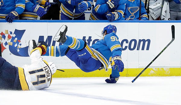 Vladimir Tarasenko of the Blues loses his stick after colliding with Mattias Ekholm of the Predators during the third period of Saturday afternoon's game in St. Louis.