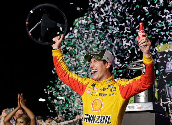 In this Nov. 18, 2018, file photo Joey Logano waves his steering wheel as confetti flies after winning the NASCAR Cup Series title at Homestead-Miami Speedway in Homestead, Fla.