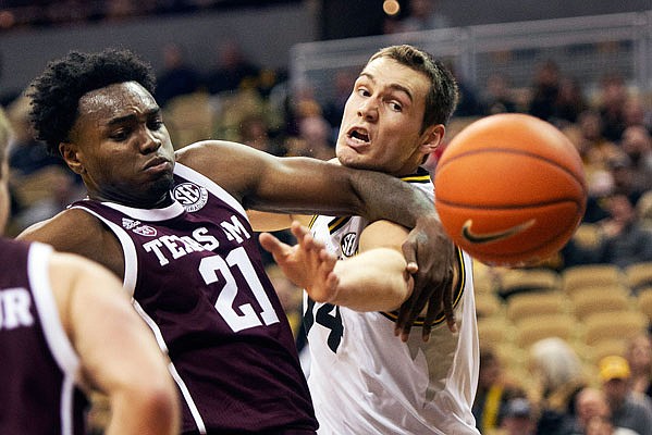 Missouri's Reed Nikko and Texas A&M's Christian Mekowulu battle for a rebound during the first half of Saturday's game at Mizzou Arena.