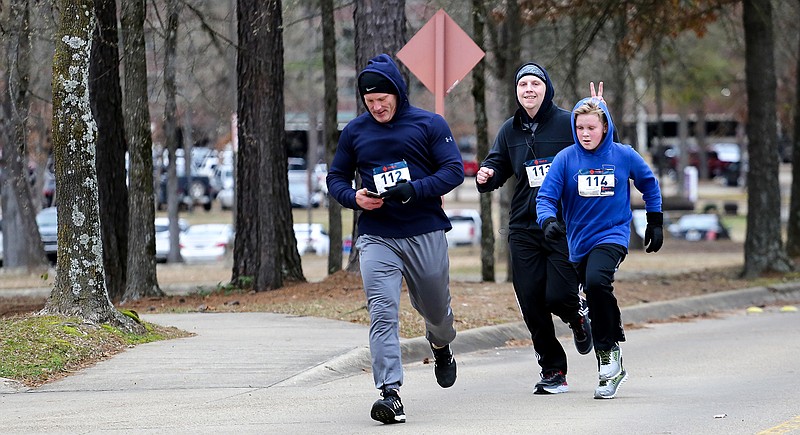 Harlo McCall and his two sons, Weston and Garrett, run toward the finish line of the Stinson Organ Donation Awareness 5K run on Saturday at CHRISTUS St. Michael Hospital in Texarkana, Texas. The fourth annual Stinson run featured a 5K and a 10K. The event benefits the Stinson Organ Transplant Awareness and Support Foundation.