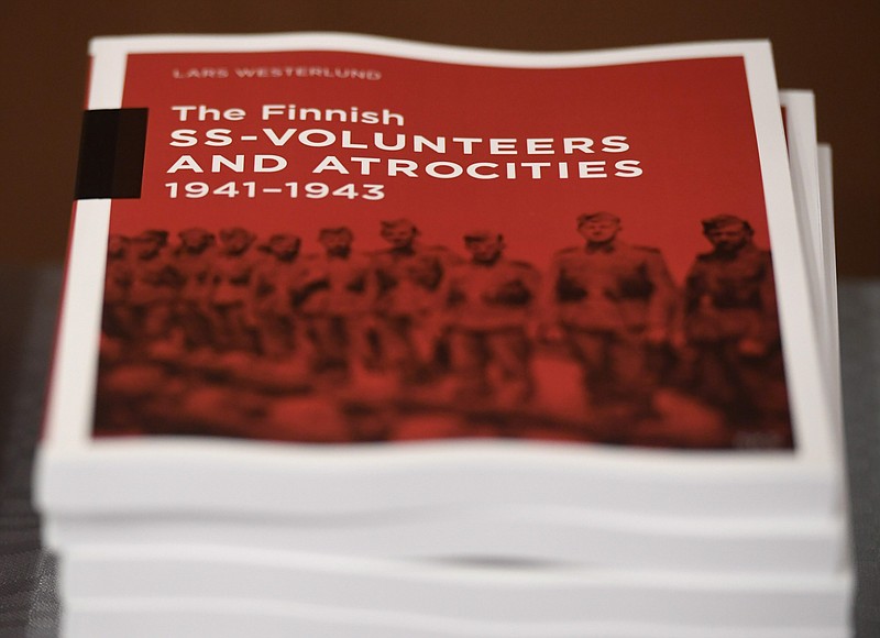 The research document entitled The Finnish SS-volunteers and atrocities 1941 - 1943 against Jews, detailing atrocities against civilians and Prisoners of War in Ukraine and the Caucasus Region, pictured in Helsinki, Finland, on Friday Feb. 8, 2019.  Senior Israeli Holocaust historian, Efraim Zuroff of the Simon Wiesenthal Center, on Sunday Feb. 10, 2019, has praised Finnish authorities for publishing a report concluding that the Nordic country's volunteer battalion serving with Nazi Germany's notorious Waffen-SS took part in atrocities during World War II including participating in the mass murder of Jews.(Heikki Saukkomaa/Lehtikuva via AP)