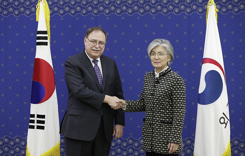 South Korean Foreign Minister Kang Kyung-wha, right, and Timothy Betts, acting Deputy Assistant Secretary and Senior Advisor for Security Negotiations and Agreements in the U.S. Department of State, shake hands for the media before their meeting at Foreign Ministry in Seoul, South Korea, Sunday, Feb. 10, 2019. (AP Photo/Lee Jin-man, Pool)