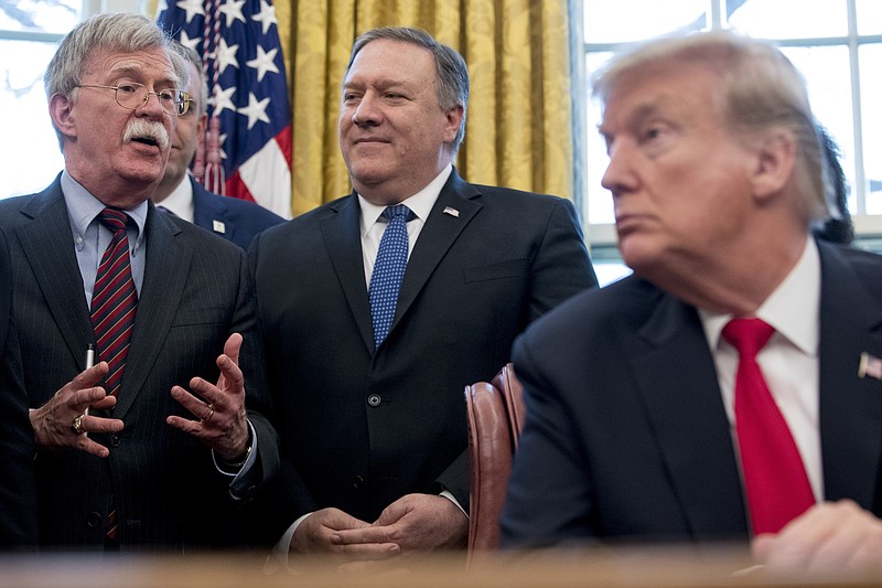From left, National Security Adviser John Bolton, accompanied by Secretary of State Mike Pompeo, and President Donald Trump, speaks before Trump signs a National Security Presidential Memorandum to launch the "Women's Global Development and Prosperity" Initiative in the Oval Office of the White House in Washington, Thursday, Feb. 7, 2019. (AP Photo/Andrew Harnik)