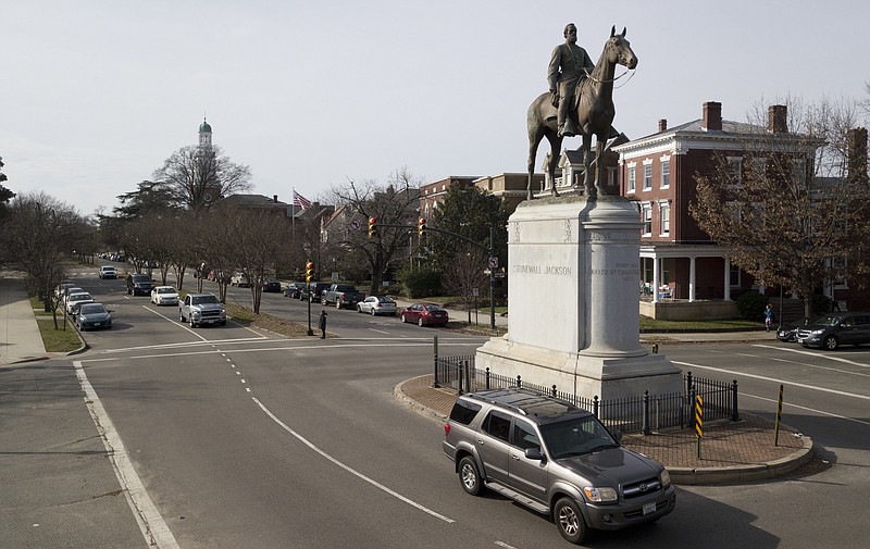 In this Jan. 27, 2019, photo traffic passes by the statue of Confederate General Stonewall Jackson at the intersection Traffic passes by the statue of Confederate General Stonewall Jackson at the intersection of Monument Avenue and The Boulevard in Richmond, Va., Sunday, Jan. 27, 2019. A city councilwoman and others are attempting to get the Boulevard named after tennis star Arthur Ashe. (AP Photo/Steve Helber)