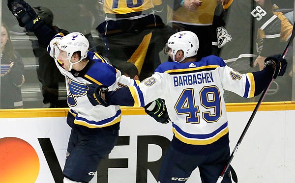 Blues right wing Vladimir Tarasenko (left) celebrates with Ivan Barbashev after Tarasenko scored the winning goal in overtime Sunday against the Predators in Nashville, Tenn.