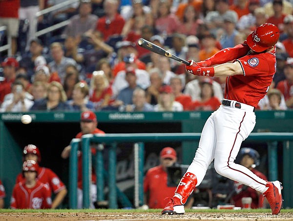 In this June 8, 2018, file photo, Bryce Harper of the Nationals hits a two-RBI double during the fifth inning of a game against the Giants in Washington.