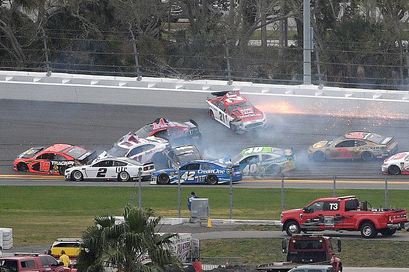 Paul Menard (21) spins in Turn 3, starting a multi-car pileup during the NASCAR Clash auto race  on Sunday at Daytona International Speedway in Daytona Beach, Fla. 