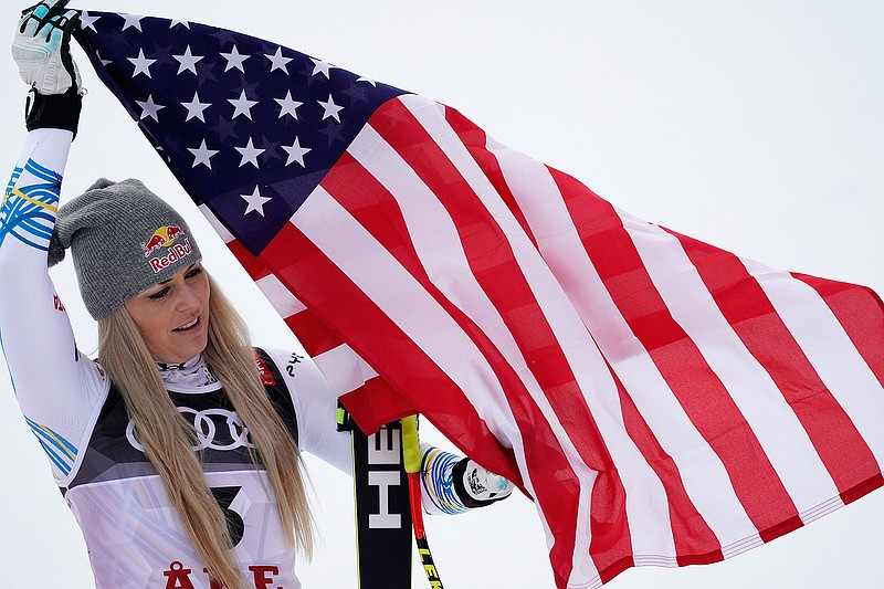 Giovanni Auletta/Associated Press
n Lindsey Vonn celebrates on the podium after placing third at the women's downhill race Sunday at the World Championships in Are, Sweden.