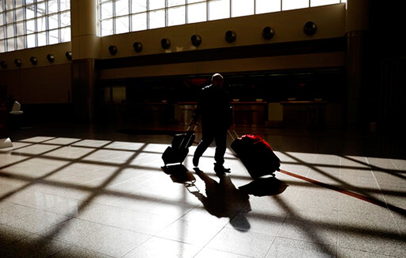 A traveler wheels his luggage through Hartsfield-Jackson Atlanta International Airport on Nov. 22, 2018,  in Atlanta. Most seniors have more free time for leisure activities including travel, but money is tighter when the paychecks stop at retirement. Retirees who want to travel can make those trips more affordable by taking advantage of senior discounts and through less obvious strategies. 

