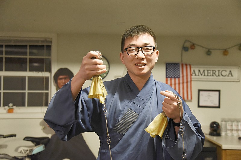 Hu shows his kung fu weapons. Cheng is a Kung Fu and Tai Chi instructor in Jefferson City. During his time in China he learned the arts from monks and brought his teaching style to Jefferson City.