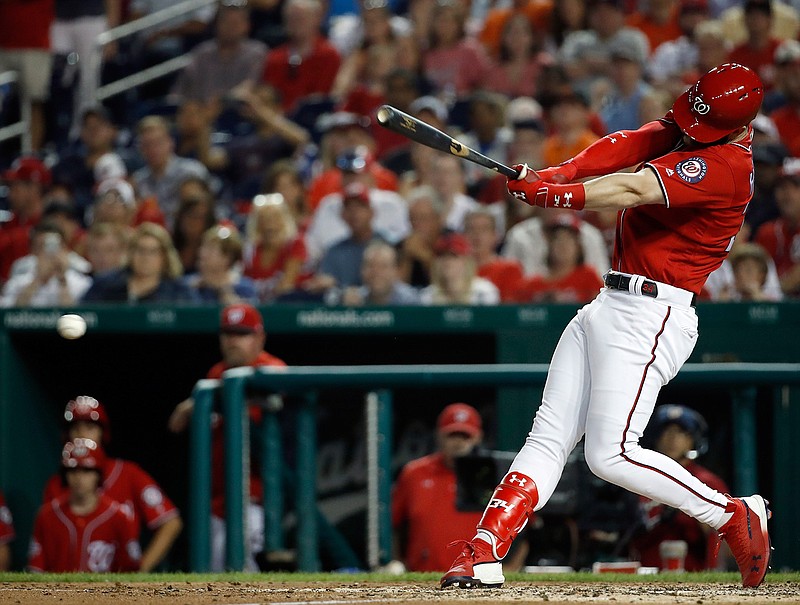  Washington Nationals' Bryce Harper hits a two-RBI double during the fifth inning of a baseball game on June 8, 2018, against the San Francisco Giants at Nationals Park in Washington. Harper, Manny Machado, Craig Kimbrel and Dallas Keuchel will not be around when the bat and ball bags are opened at spring training throughout Florida and Arizona this week. They are among the dozens of free agents still looking for jobs. 