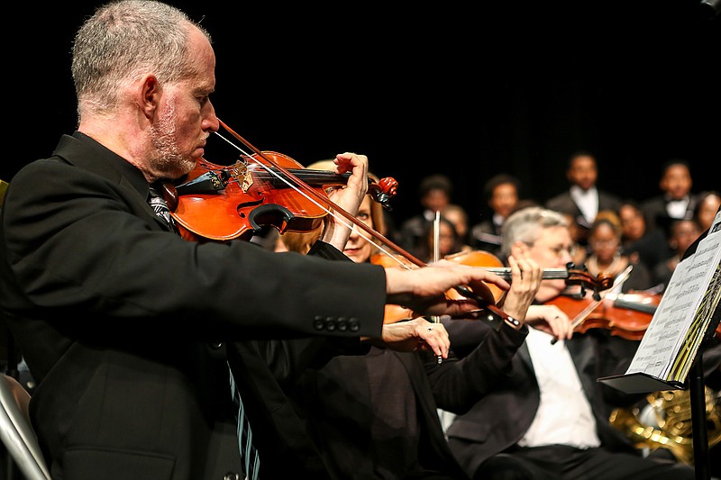 Members of the Texarkana Regional Orchestra, above, play "Lift Every Voice and Sing" by J. Rosamond Johnson, arranged by Roland Carter, at Sunday's SoulFest at the Sullivan Performing Arts Center in Texarkana, Texas. SoulFest is a concert that is part of February's  Black History month celebration. Below, the orchestra plays and the choir sings "Joshua Fit the Battle of Jericho," arranged by John Rutter, while being directed by Marc-André Bougie.