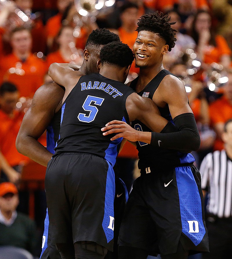 Duke's Zion Williamson, left, RJ Barrett (5) and Cam Reddish celebrate the team's 81-71 victory over Virginia on Saturday during an NCAA college basketball game in Charlottesville, Va.