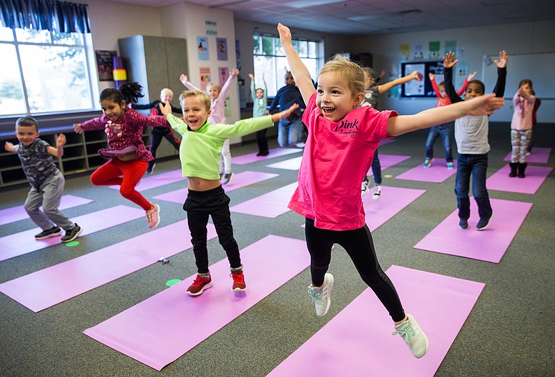 Charlotte Mayer, right, and other kindergarten students participate in a yoga class Jan. 24, 2019, at Pink Elementary in Frisco, Texas.
