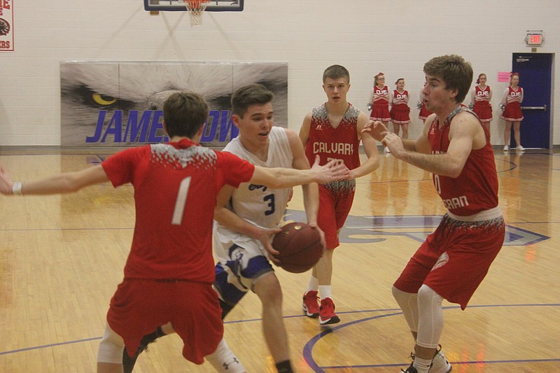 Tristan Jones goes through Calvary Lutheran defenders Feb. 8 during the Eagles 56-38 win.