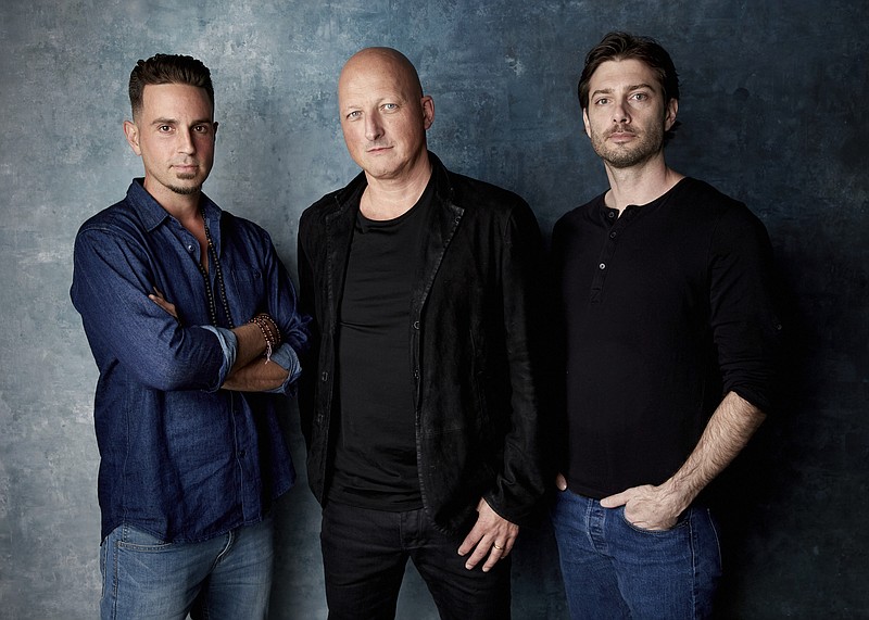 FILE - In this Jan. 24, 2019, file photo, Wade Robson, from left, director Dan Reed and James Safechuck pose for a portrait to promote the film "Leaving Neverland" at the Salesforce Music Lodge during the Sundance Film Festival in Park City, Utah. The Michael Jackson estate has sent a letter to the U.K.’s Channel 4 warning that the documentary on Robson and Safechuck, who accuse the singer of molesting them as boys violates the network's programming guidelines. Estate attorneys say in the letter released to The Associated Press on Monday, Feb. 11, that "Leaving Neverland," includes no response from Jackson defenders as the channel's guidelines require. (Photo by Taylor Jewell/Invision/AP, File)