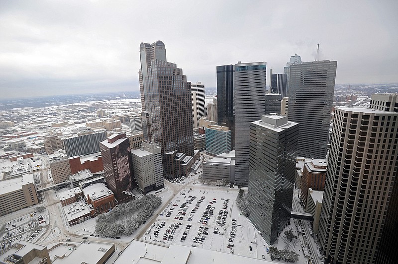 A snow-covered skyline can be seen from the 37th floor of the Sheraton Dallas on Feb. 4, 2011. The Dallas suburb of Arlington offers Via on-demand rideshare services in lieu of public transportation.  Like Uber or Lyft, passengers can hail a Via ride using an app on their smartphone. But unlike those services, Via won't pick passengers up at their doorstep but will provide a pickup location within a short walk. 